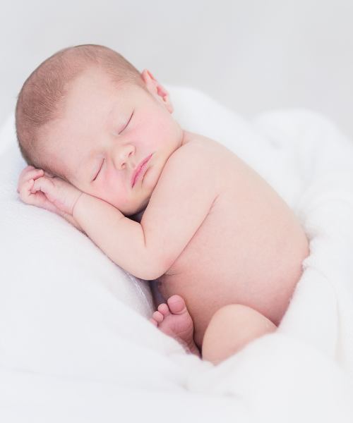 Obstetrician assisting mother during normal childbirth process